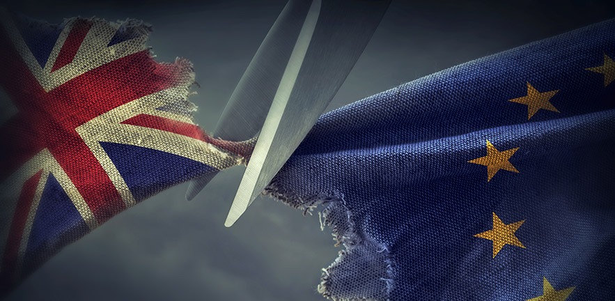 Flags of the United Kingdom and the European Union being cut apart with a pair of scissors.
